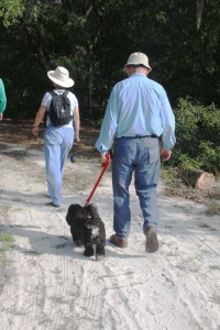 A couple walks their dog on the Sweetwater Preserve trail