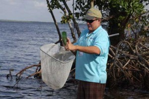 FOWA member Rodney Smith checks to see if any sealife lives inside this discarded bottle